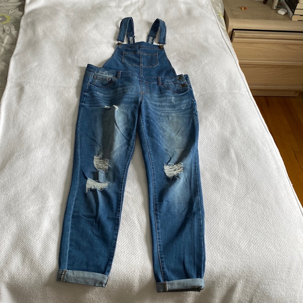 Ripped denim overalls.